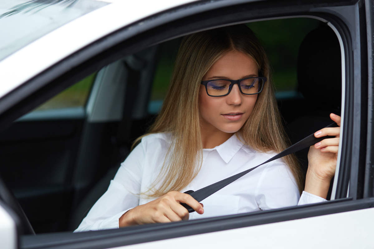 st. louis woman putting seatbelt on