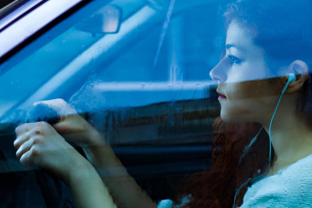 girl wearing headphone while driving