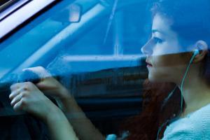 girl wearing headphone while driving