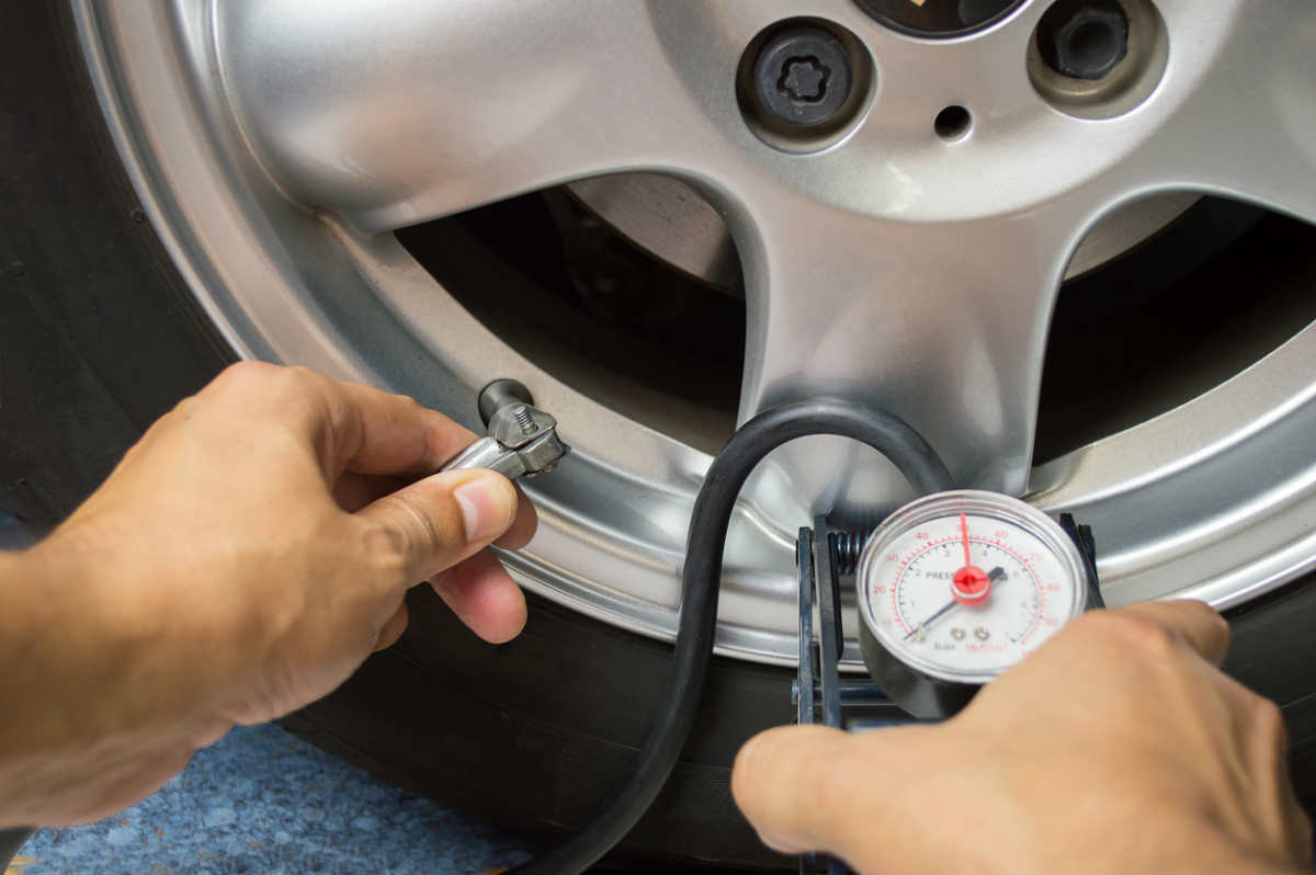 St. Louis man checking tire pressure