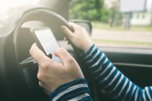 female driver distracted by cell phone
