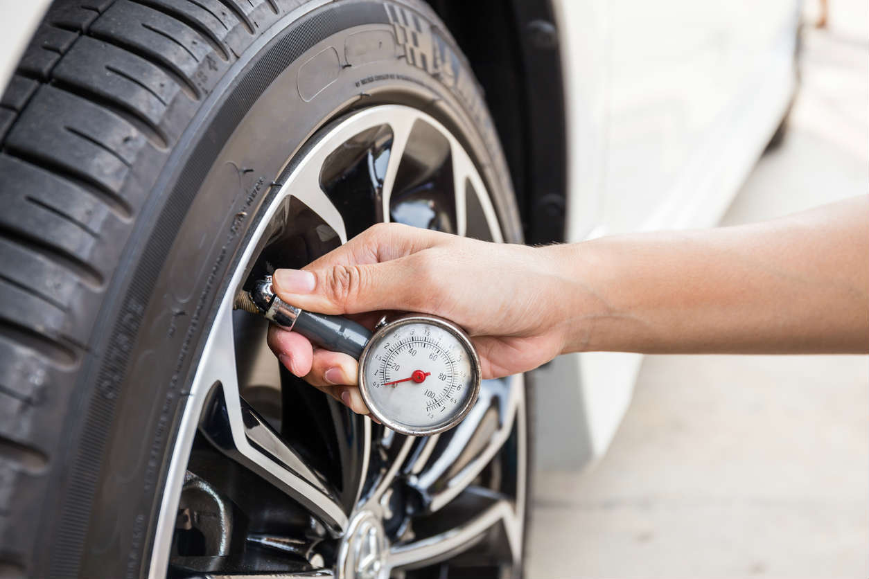 St. Louis man checking tire pressure