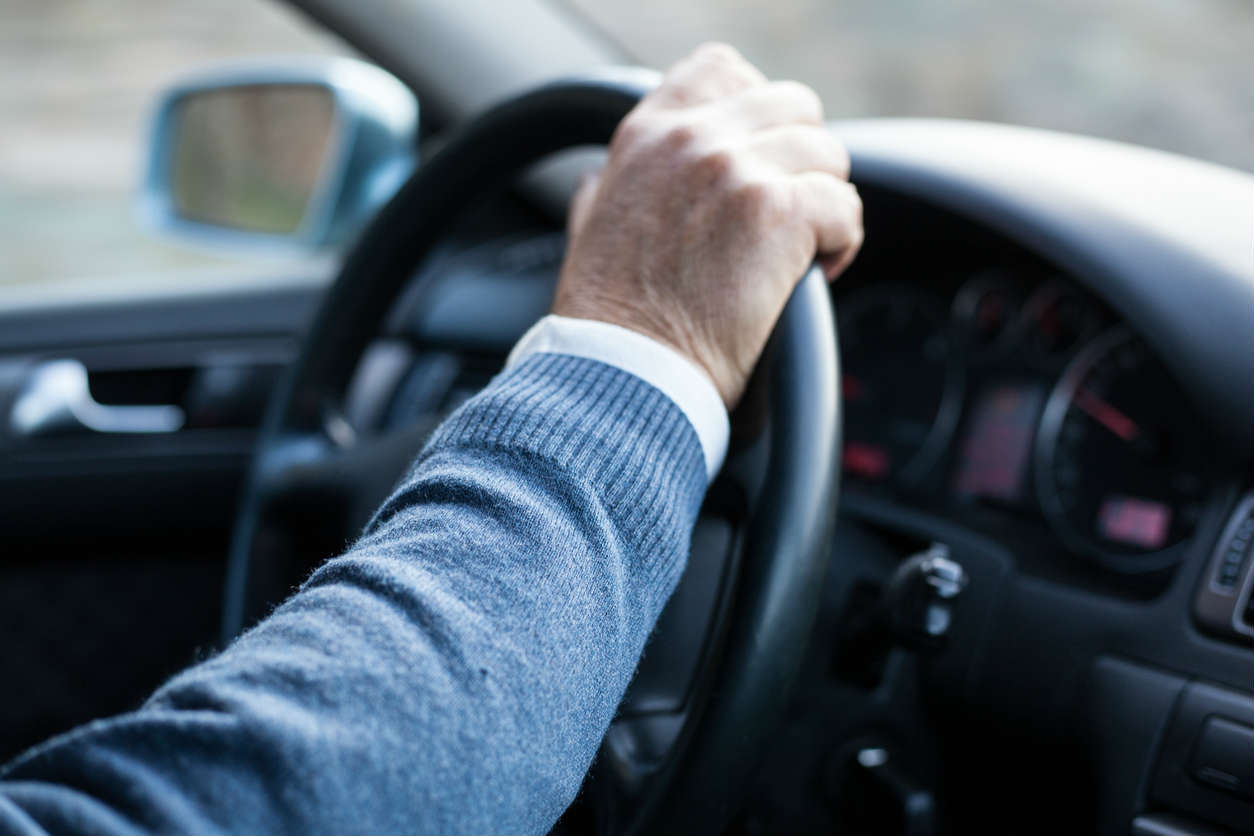 St. Louis man with hand on steering wheel