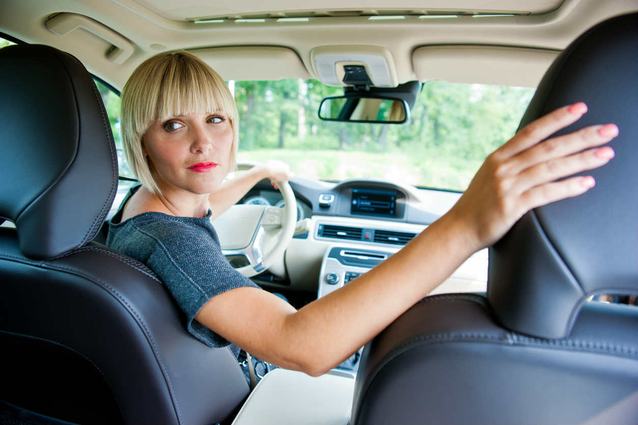 St. Louis woman backing car up