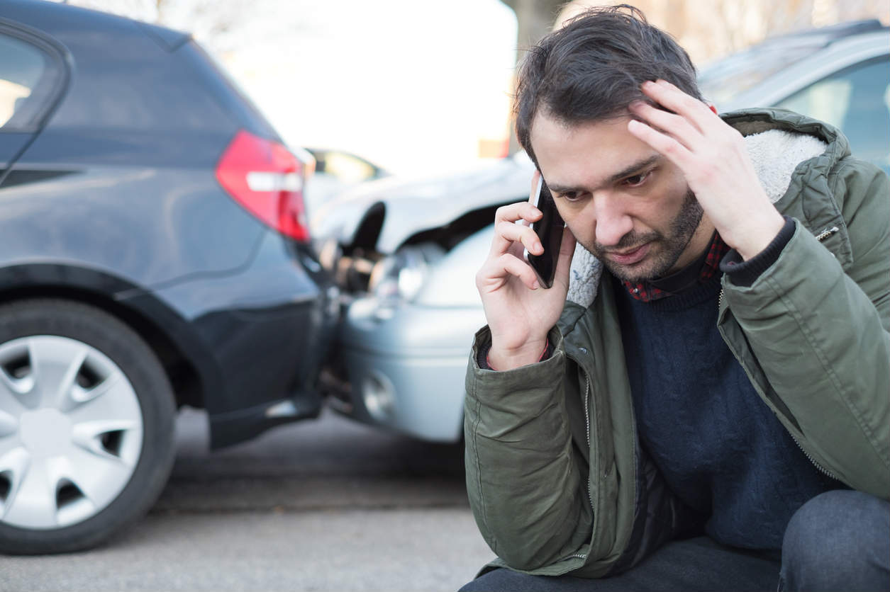 man on the phone after car accident