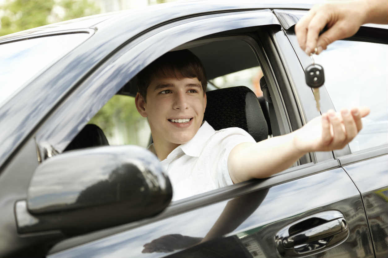 car keys being handed to a teen driver