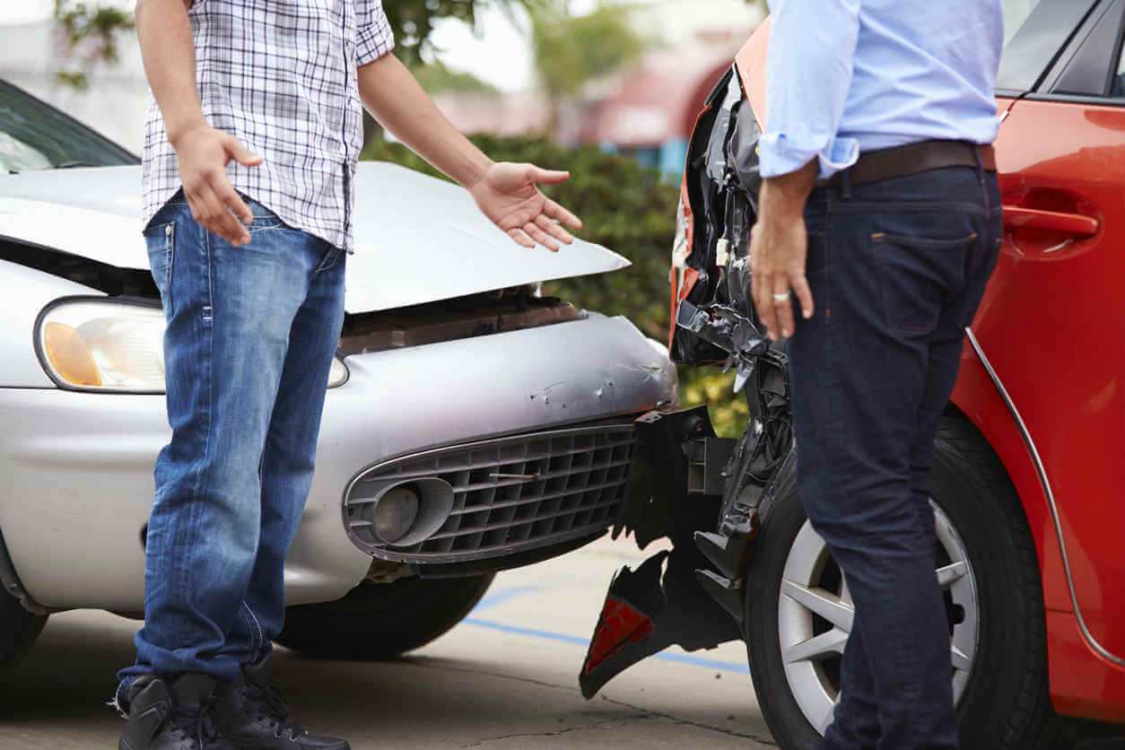 Two men talking after a car accident