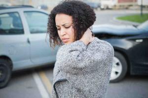 woman holding her neck after a car accident