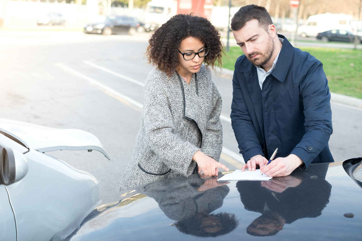 St. Louis man and woman exchanging information after car accident