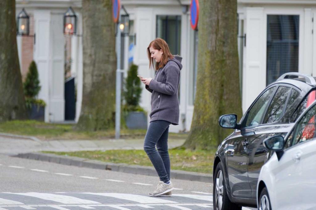 pedestrian walking in street texting