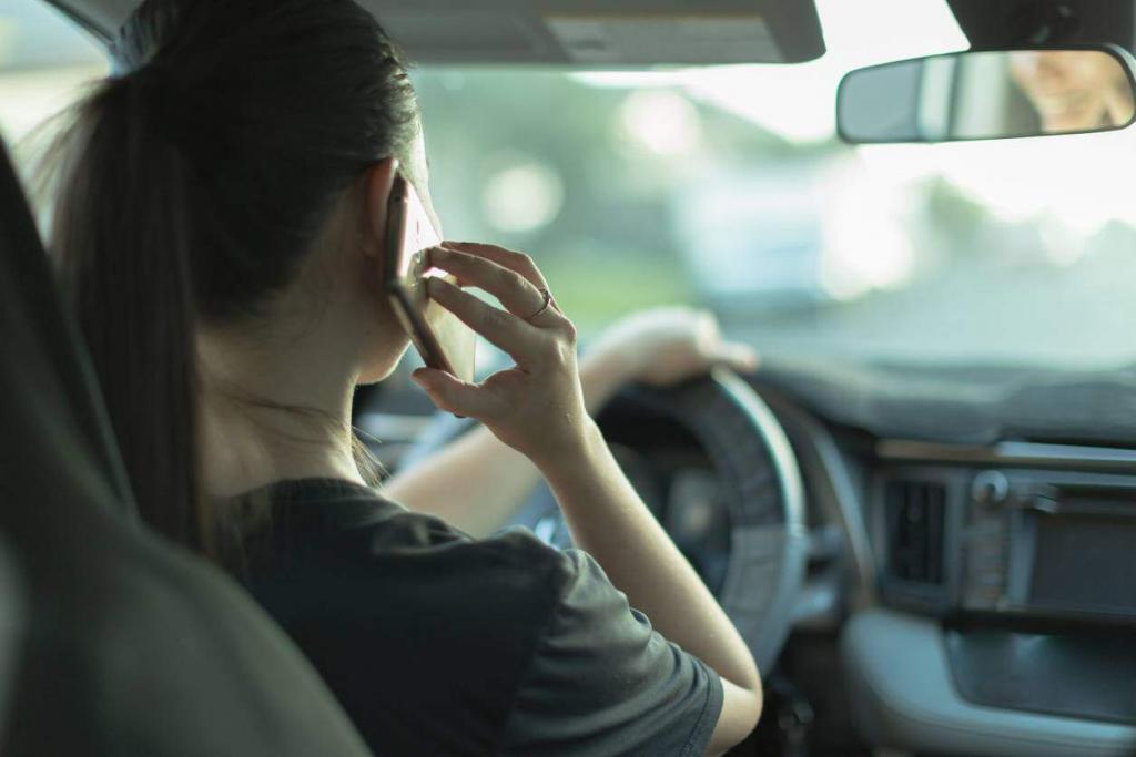 young woman on phone while driving