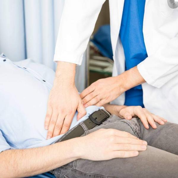 doctor examining abdomen