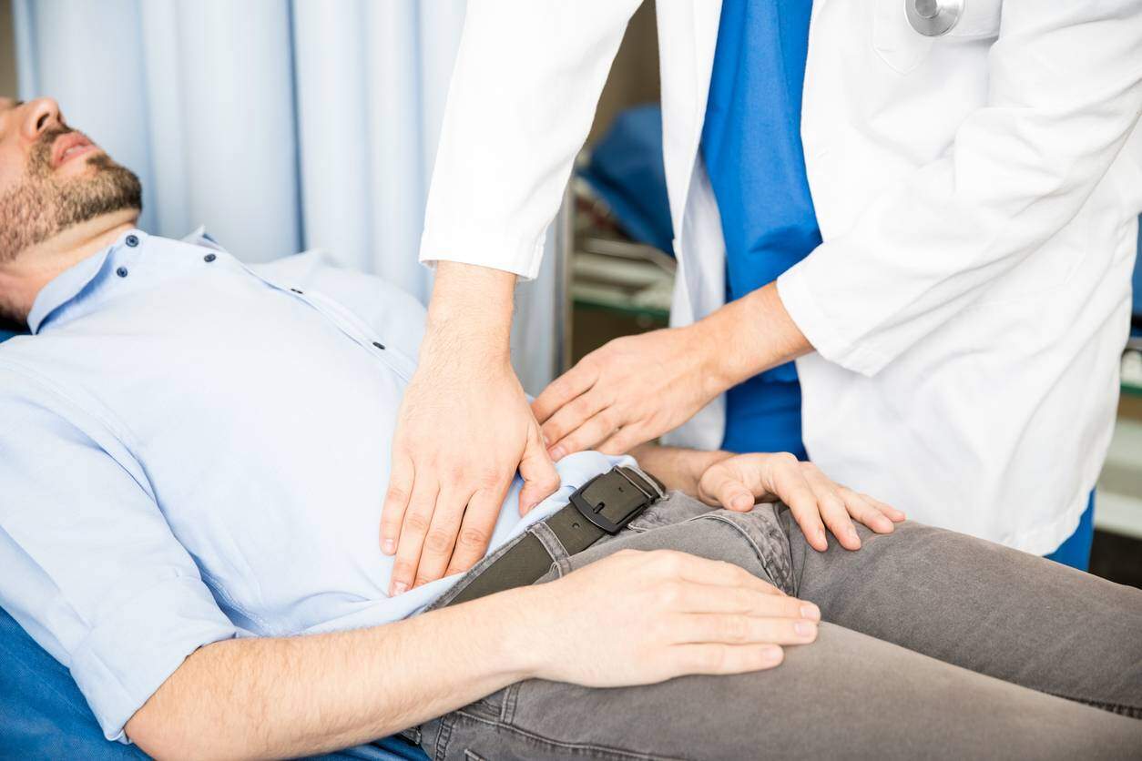doctor examining abdomen