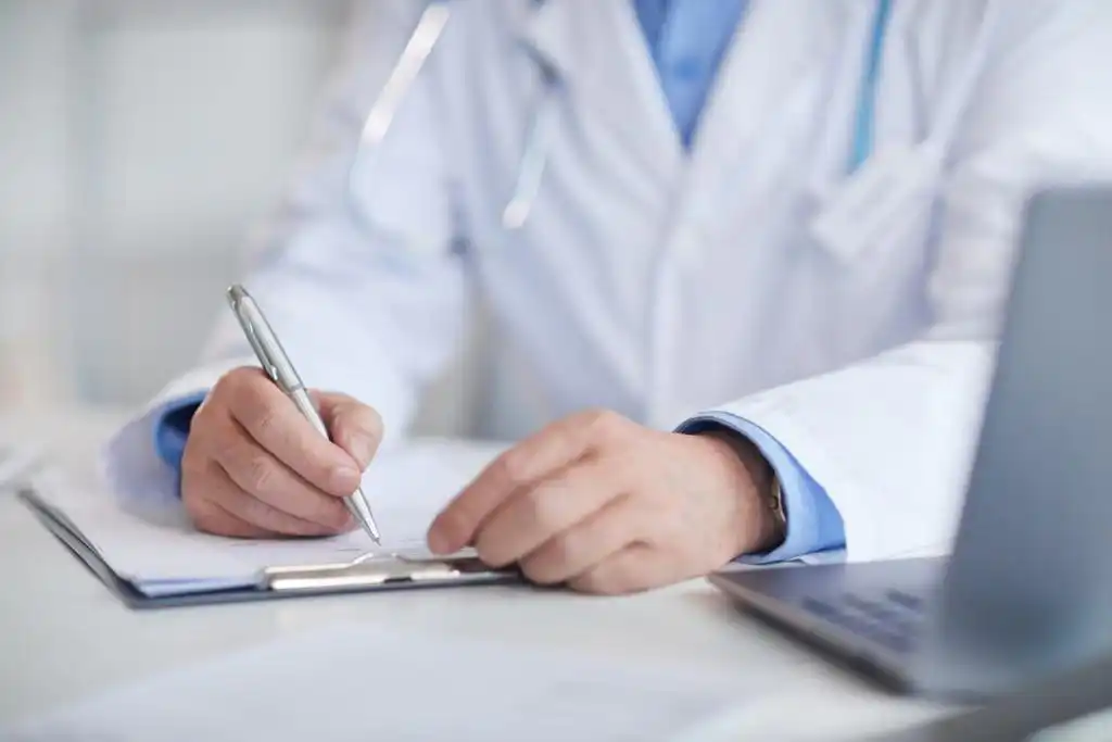 St. Louis doctor filling out medical record after car accident