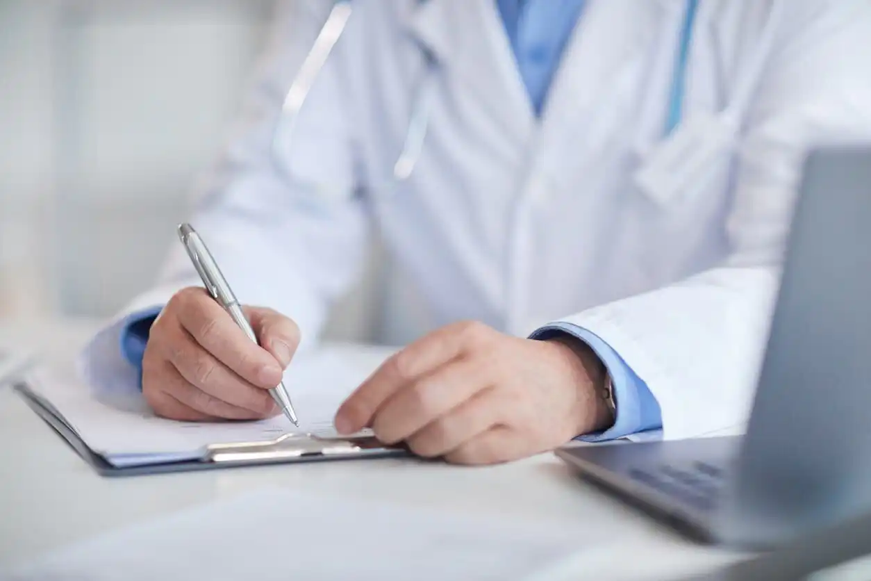 St. Louis doctor filling out medical record after car accident