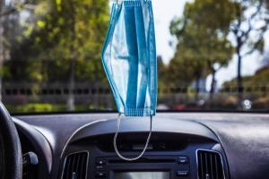 face mask hanging from car window