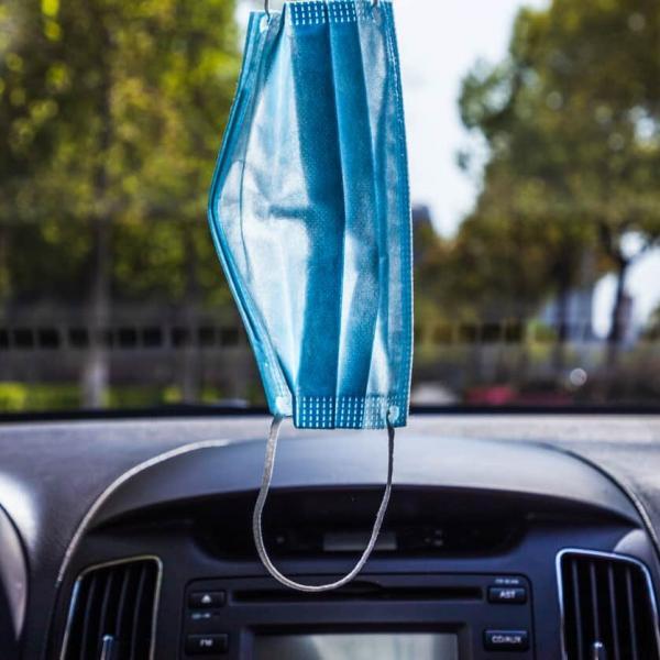 face mask hanging from car window