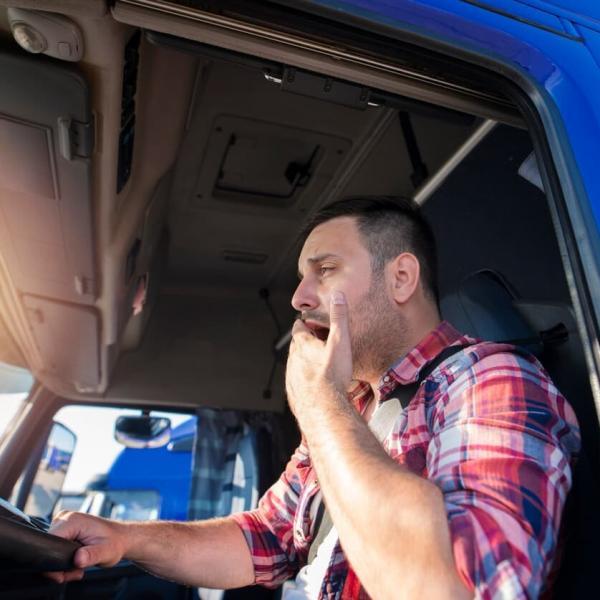 fatigued truck driver yawning