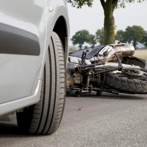 motorycle that has been hit by a car