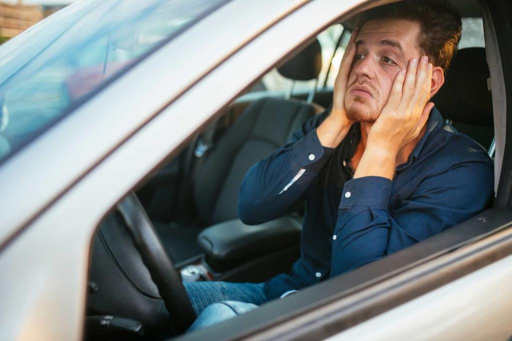 young man stuck in traffic