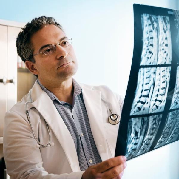 doctor looking at mri of spinal cord