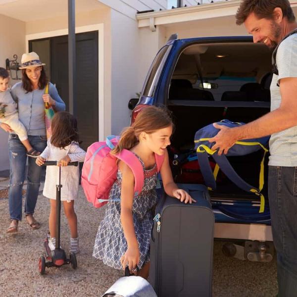 family packing their car for a road trip