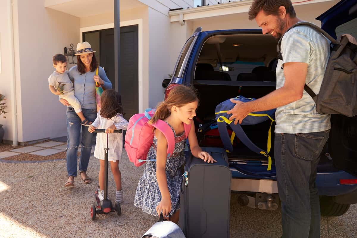 family packing their car for a road trip