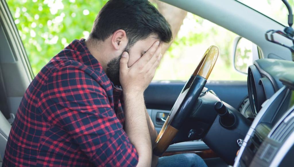 man having a panic attack while driving