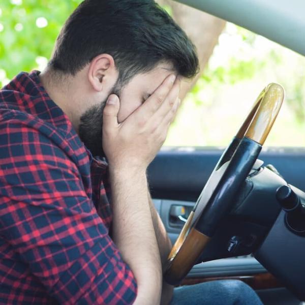 man having a panic attack while driving
