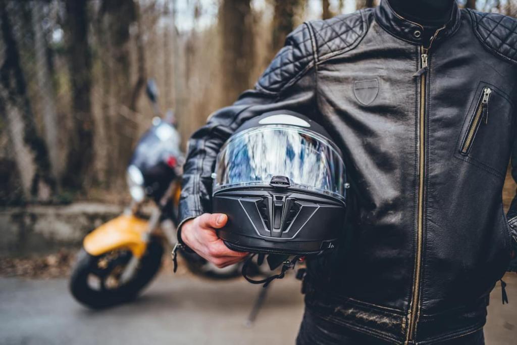 motorcyclist holding his helmet