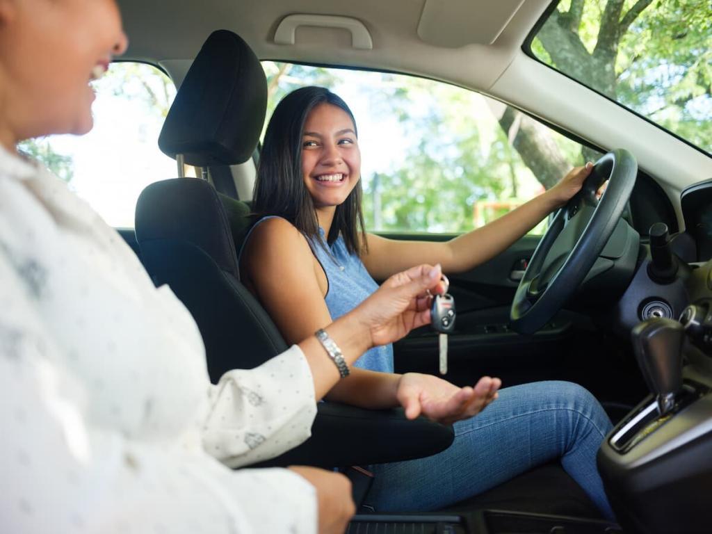 a mother teaches her daughter to drive