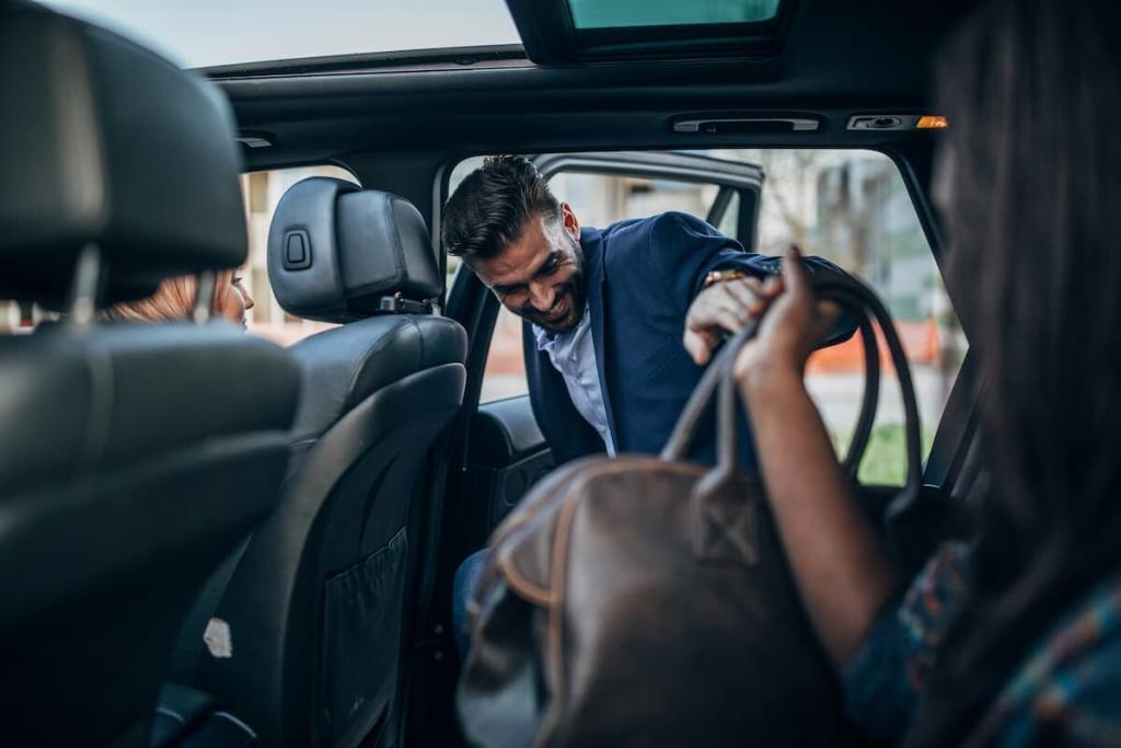 man getting into the backset of an automobile