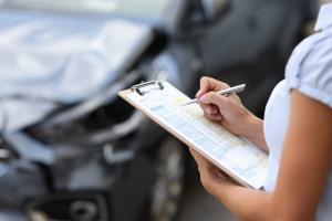 insurance adjuster investigating damage after a car accident