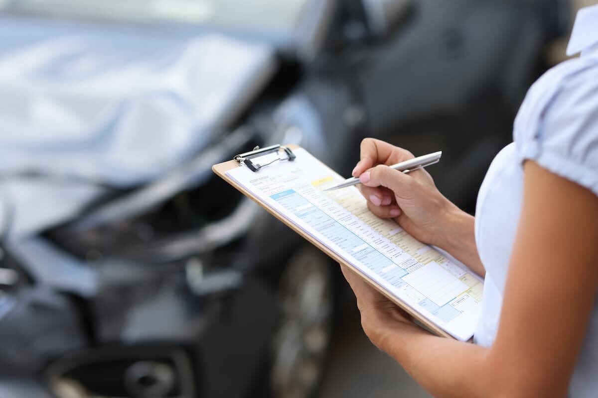 insurance adjuster investigating damage after a car accident