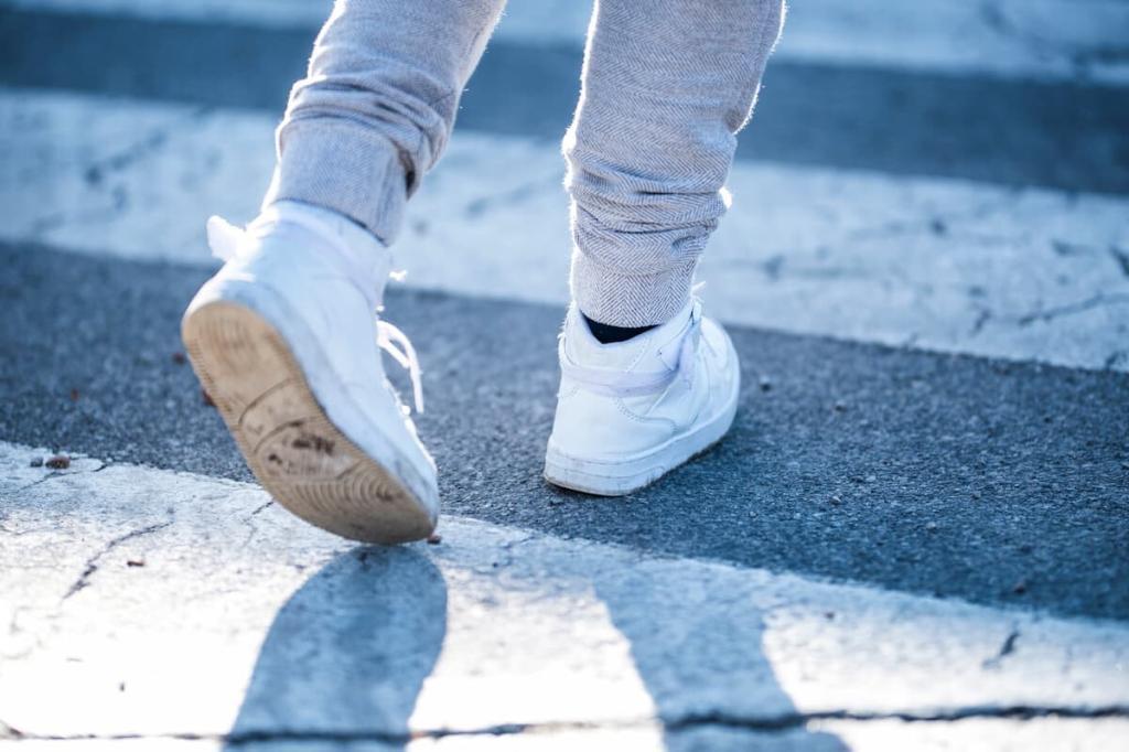 the shoes of a child crossing the road