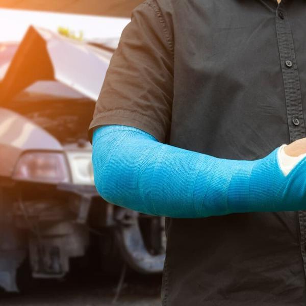 man's arm in a cast after a car accident