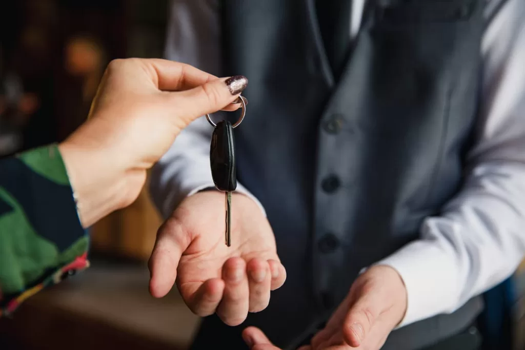 a driver handing their keys to a valet service