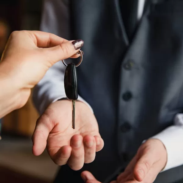 a driver handing their keys to a valet service