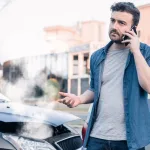 man calling a lawyer after an uninsured motorist accident in Missouri